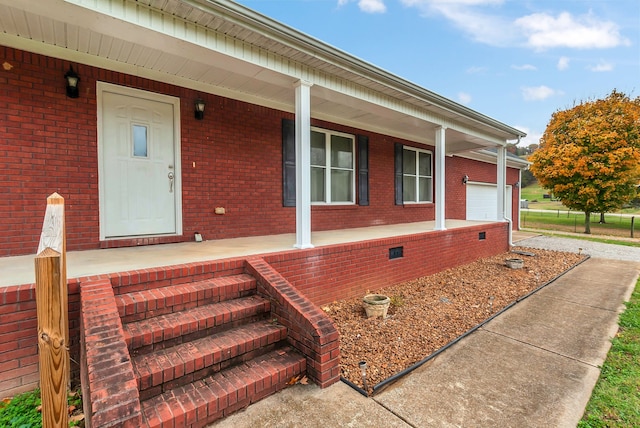 doorway to property featuring a garage and covered porch