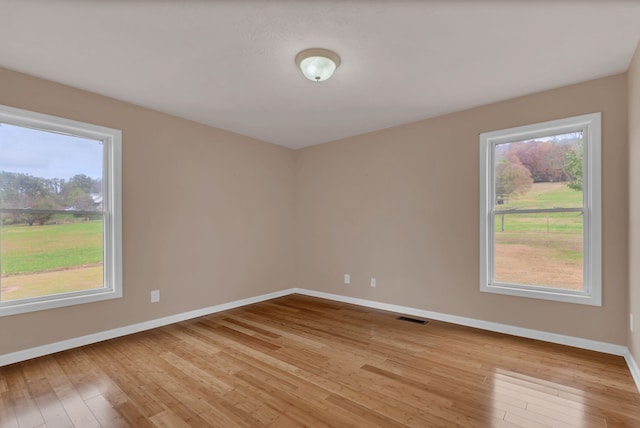 spare room with light hardwood / wood-style flooring