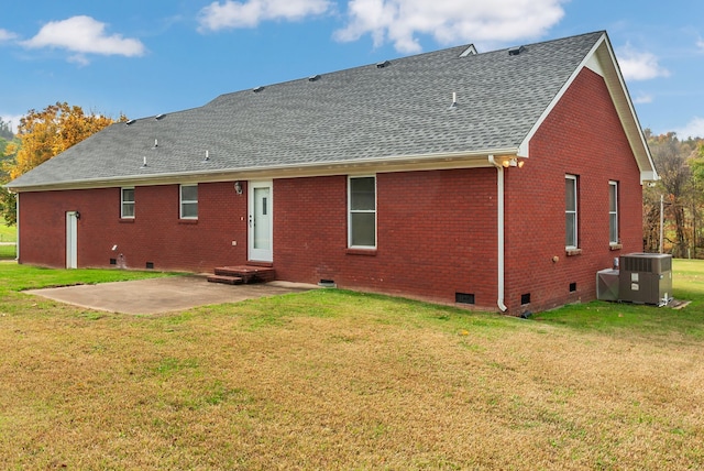 back of property with cooling unit, a lawn, and a patio area