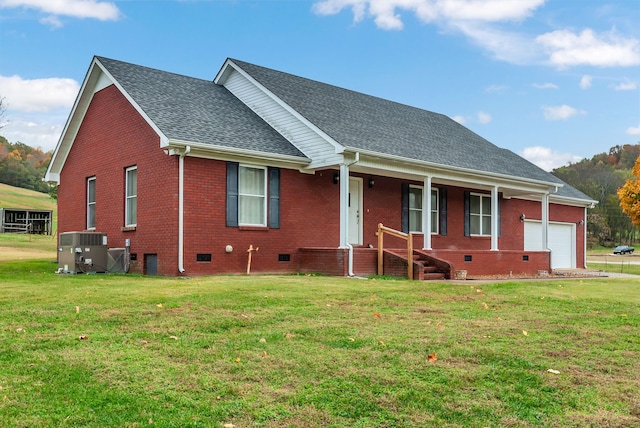 view of front facade with a garage, a porch, cooling unit, and a front lawn