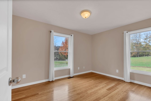 empty room with light hardwood / wood-style flooring