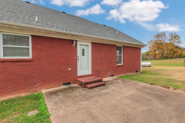 rear view of property featuring a lawn and a patio