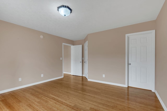 spare room with hardwood / wood-style flooring and a textured ceiling