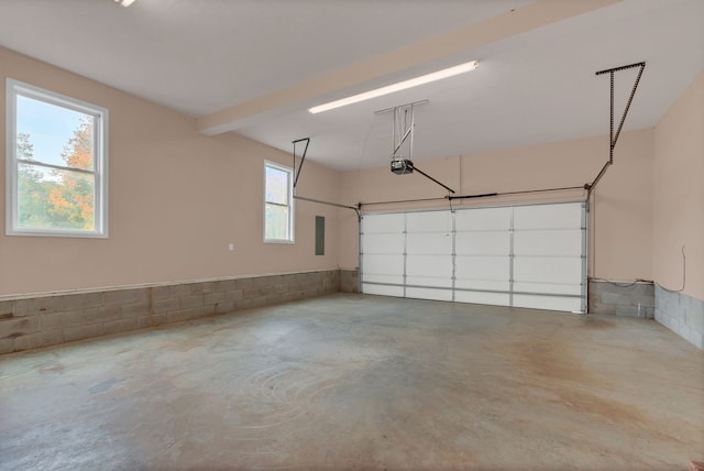 garage with electric panel and a garage door opener