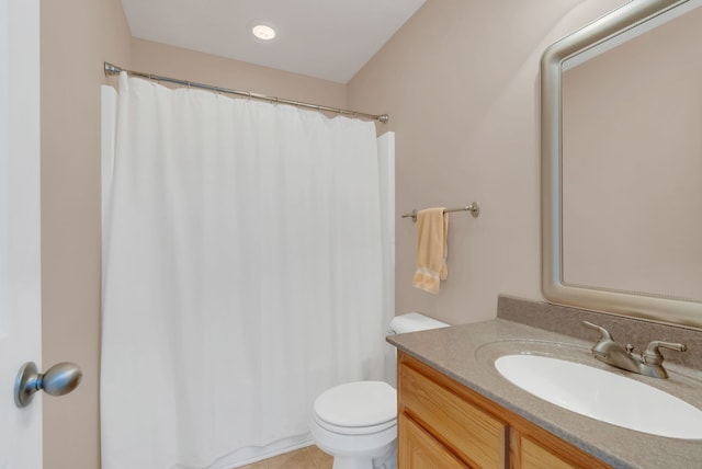 bathroom featuring tile patterned flooring, vanity, and toilet