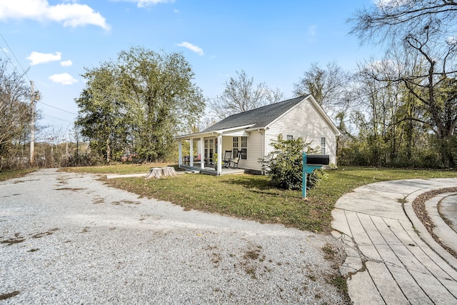 exterior space featuring a front lawn and covered porch