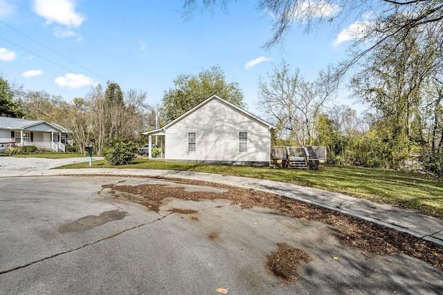 view of property exterior featuring a lawn