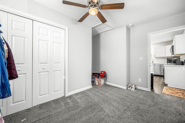 interior space with ceiling fan, a closet, and dark colored carpet