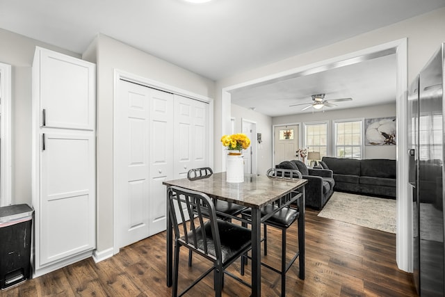 dining room with ceiling fan and dark hardwood / wood-style floors