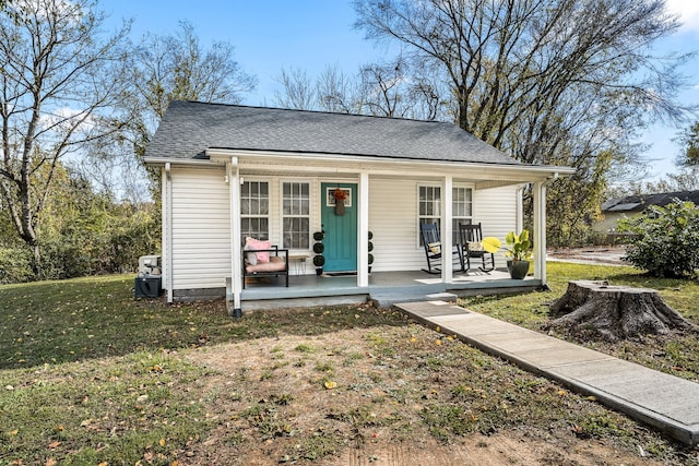 bungalow-style house with a porch and a front lawn