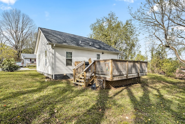 back of property featuring a lawn and a deck