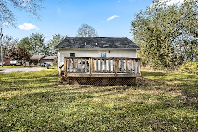 back of property featuring a yard and a wooden deck