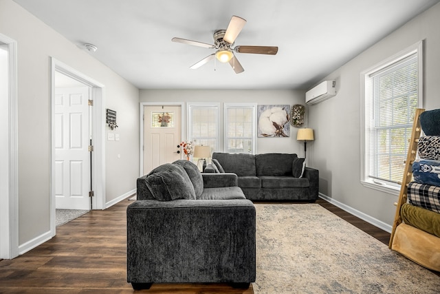 living room with a wall mounted air conditioner, ceiling fan, dark wood-type flooring, and plenty of natural light