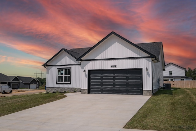 modern inspired farmhouse with a garage, central air condition unit, and a lawn