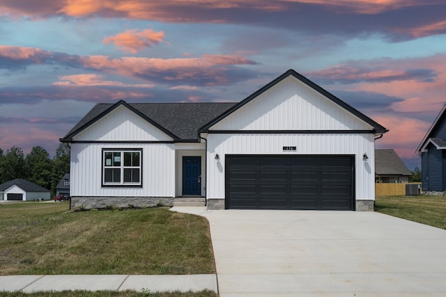 modern farmhouse featuring a garage, a lawn, and cooling unit