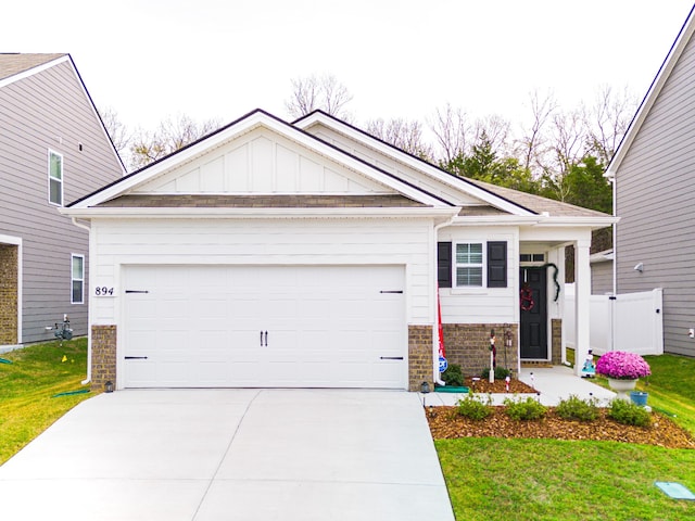 craftsman inspired home with a front yard and a garage