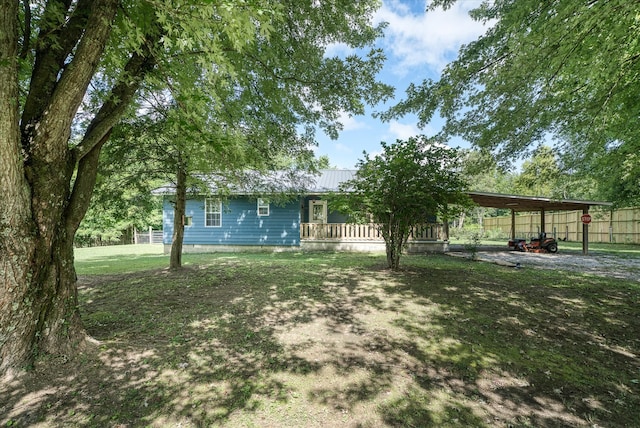 view of yard with covered porch and a carport