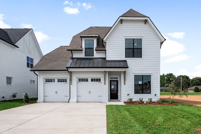 view of front of property with a garage and a front yard