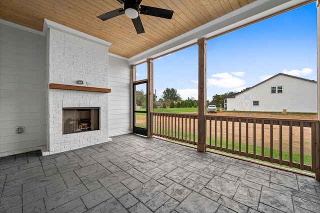 view of patio with ceiling fan and an outdoor fireplace