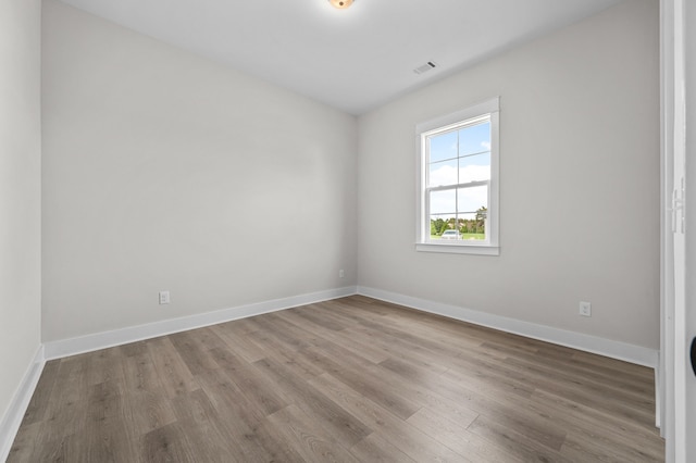 unfurnished room with light hardwood / wood-style floors