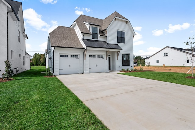 view of front facade with a garage and a front yard