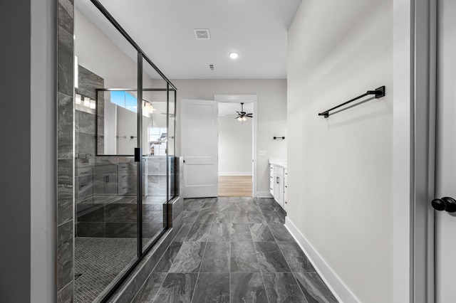 bathroom featuring walk in shower, ceiling fan, and vanity