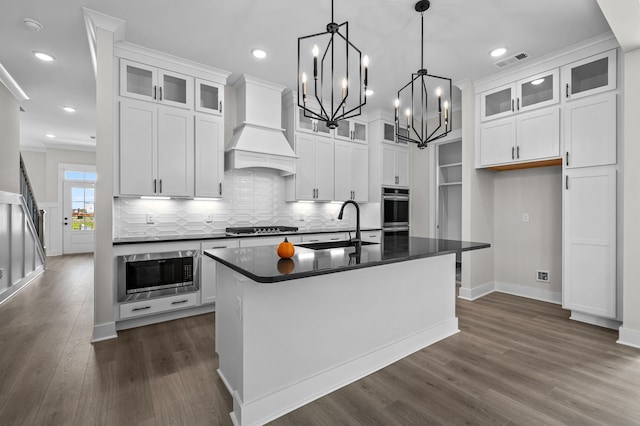 kitchen with white cabinetry, an island with sink, and stainless steel appliances