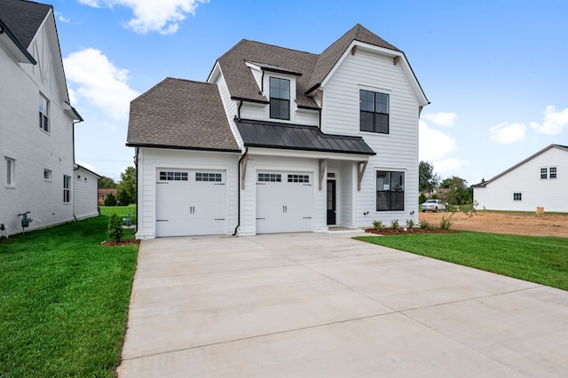 view of front of property with a garage and a front lawn