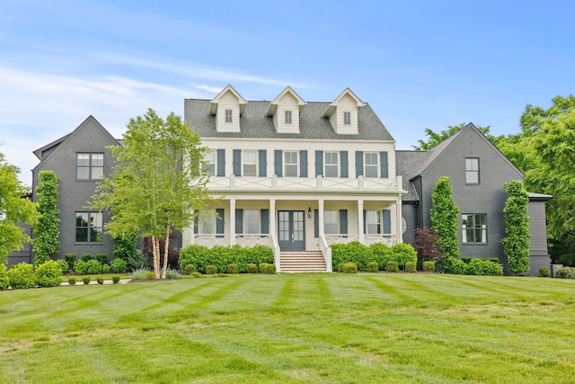 colonial inspired home with a porch and a front lawn