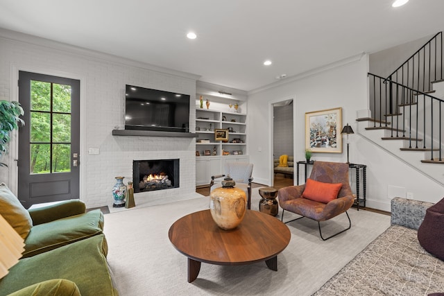 living room with ornamental molding and a fireplace