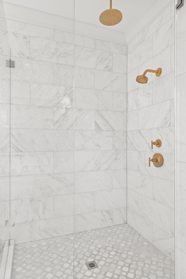 bathroom featuring an enclosed shower and crown molding