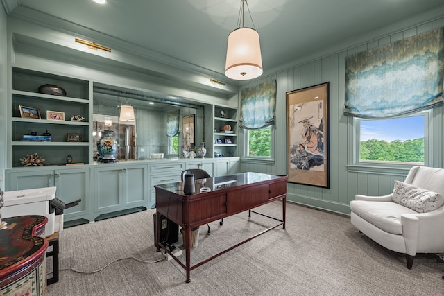 home office with light colored carpet, wooden walls, built in shelves, and ornamental molding