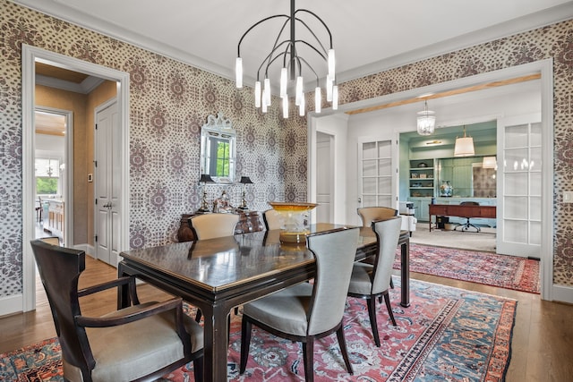 dining room featuring a chandelier, french doors, hardwood / wood-style flooring, and crown molding