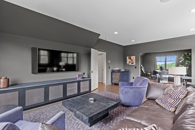 living room with light hardwood / wood-style floors and crown molding