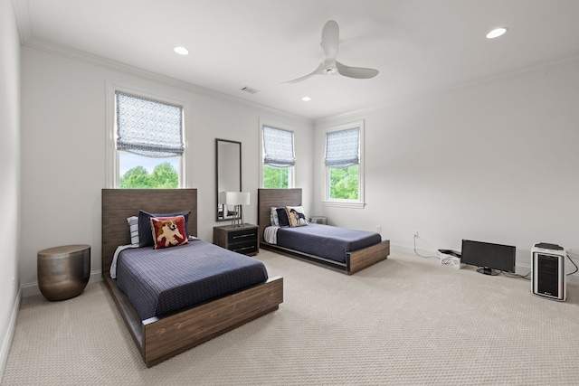 carpeted bedroom featuring ornamental molding and ceiling fan