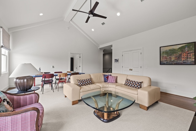 living room featuring high vaulted ceiling, hardwood / wood-style flooring, ceiling fan, and beam ceiling