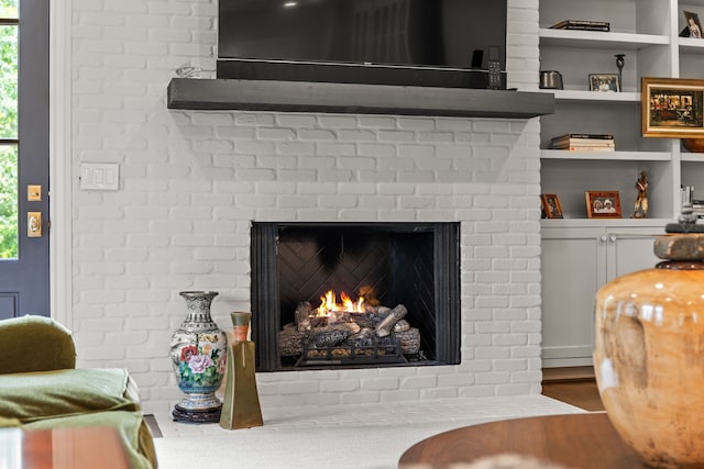 interior details with built in features and a brick fireplace