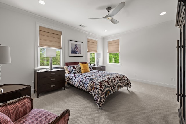 carpeted bedroom featuring ornamental molding, multiple windows, and ceiling fan