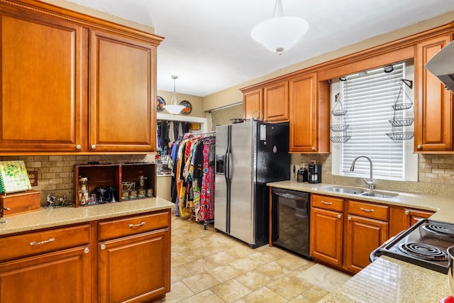 kitchen with a sink, black dishwasher, refrigerator with ice dispenser, and light countertops