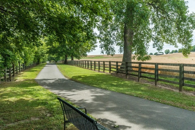 surrounding community featuring a yard, a rural view, and fence