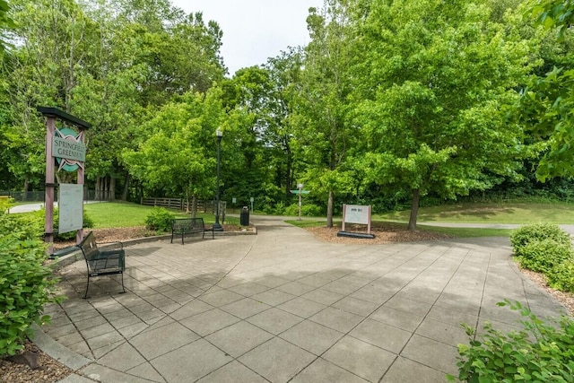 surrounding community featuring fence and a lawn