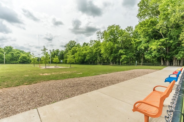 surrounding community with a lawn and fence