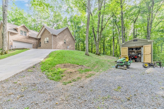 view of yard with a garage and an outbuilding