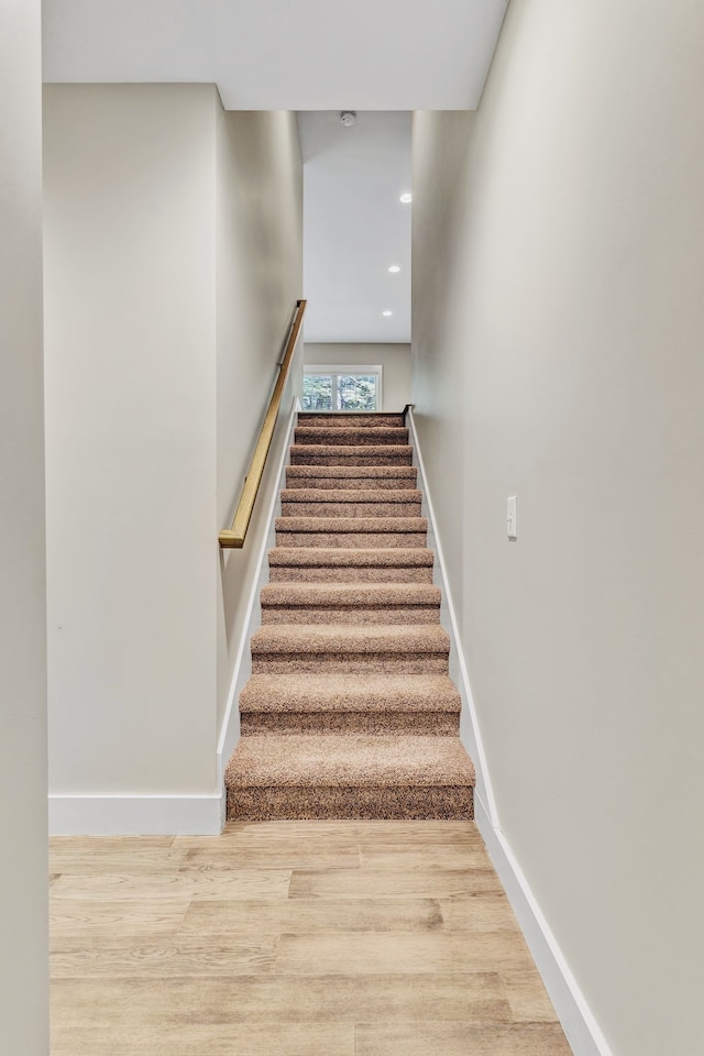 stairway featuring hardwood / wood-style floors