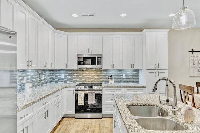 kitchen with white cabinetry, sink, and appliances with stainless steel finishes