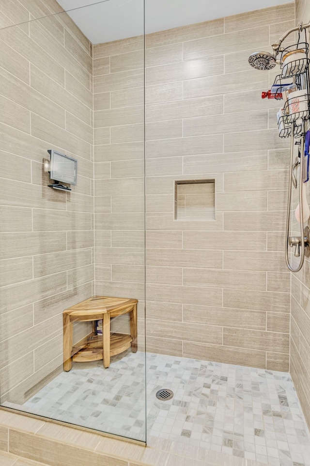 bathroom with tiled shower