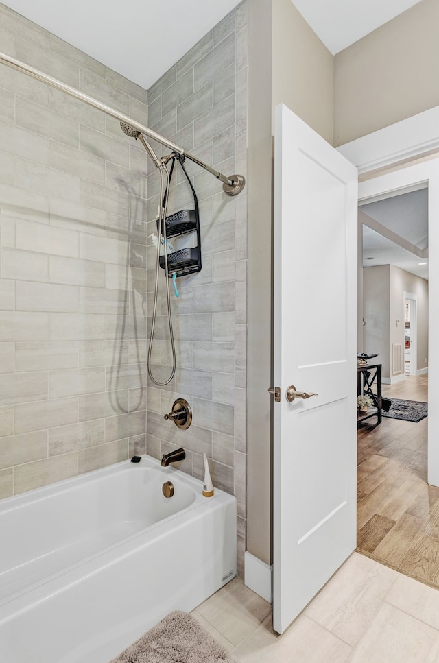 bathroom featuring hardwood / wood-style floors and tiled shower / bath combo