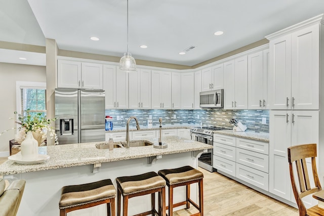 kitchen with white cabinetry, appliances with stainless steel finishes, and sink