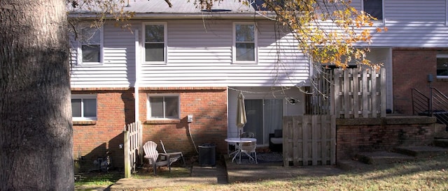 rear view of property featuring central air condition unit