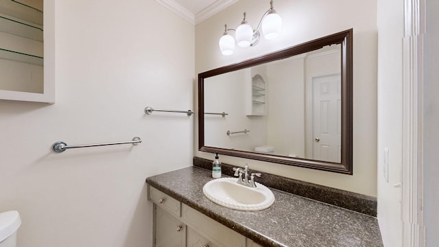 bathroom featuring vanity, toilet, and ornamental molding